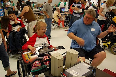 Fantastic photo of a daughter and her Dad playing Guitar Hero at AbleGames 2009.