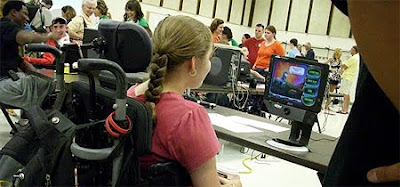 Image of a young woman playing Peggle using Eye Control.
