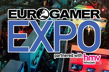 High up photo of the EuroGamer Expo hall in 2009, full of people and games machines. The text reads 'EuroGamer Expo 2010, partnered with HMV. Links with the attendance of the Accessible GameBase.