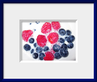 Berries by Julie Magers Soulen A bowl of fresh red raspberries and blueberries splashed with milk makes a healthy breakfast still life.
