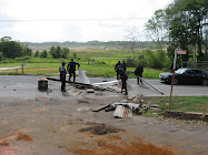 Police clear debris on main road in front of Union Village (9th June, 2009)