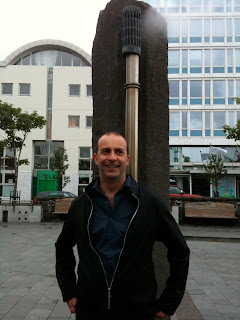 a man standing in front of a metal pipe