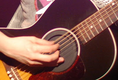 Tegan Quin of Tegan and Sara - fingers on guitar close-up