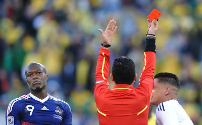 France's striker Djibril Cisse reacts as Colombian referee Oscar Ruiz gives France's striker Djibril Cisse reacts as Colombian referee Oscar Ruiz gives