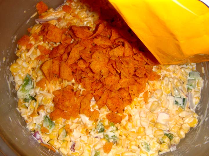 Corn chips in the bag with your hands pour and cover the creamy salad Corn chips in the bag with your hands pour and cover the creamy salad