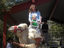 Addison and Gigi riding the camel
