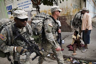 Members of the 82nd Airborne Division of the “U.S.” Army patrolling the streets of Port Au Prince, January 19, 2010