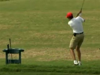 Obama swinging a golf club