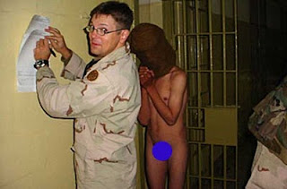 This picture is from the Salon Abu Ghraib files. The “American” soldier is identified as a “Sergeant Evans.”