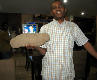 Turay shows me the difference between a yam and a sweet potato — about 5 Turay shows me the difference between a yam and a sweet potato — about 5