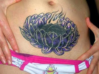 women Tattoos on the belly with a lotus flower motif