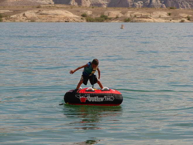 Korben, trying to balance on the tube. did pretty good till dad swam out and then he jumped off