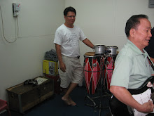 Mr Oh Kim Huat on the bongos and Mr Woon on lead guitar