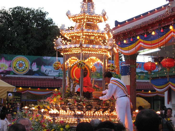 Mr Joy Chan sprinkling bunga rampai round the Buddha chariot