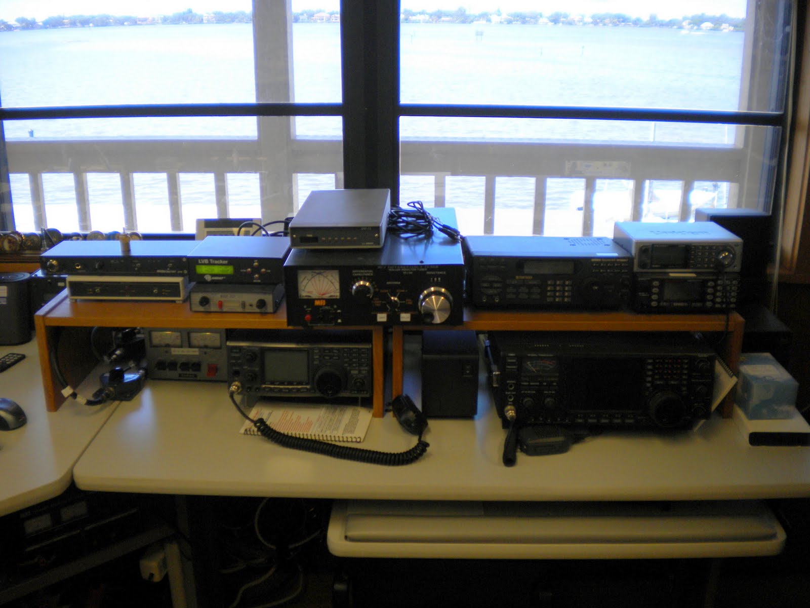 Another large desk is packed with lots of ham radio gear. Another large desk is packed with lots of ham radio gear.