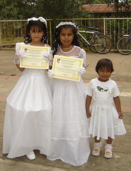 Proudly clutching their official Communion certificates