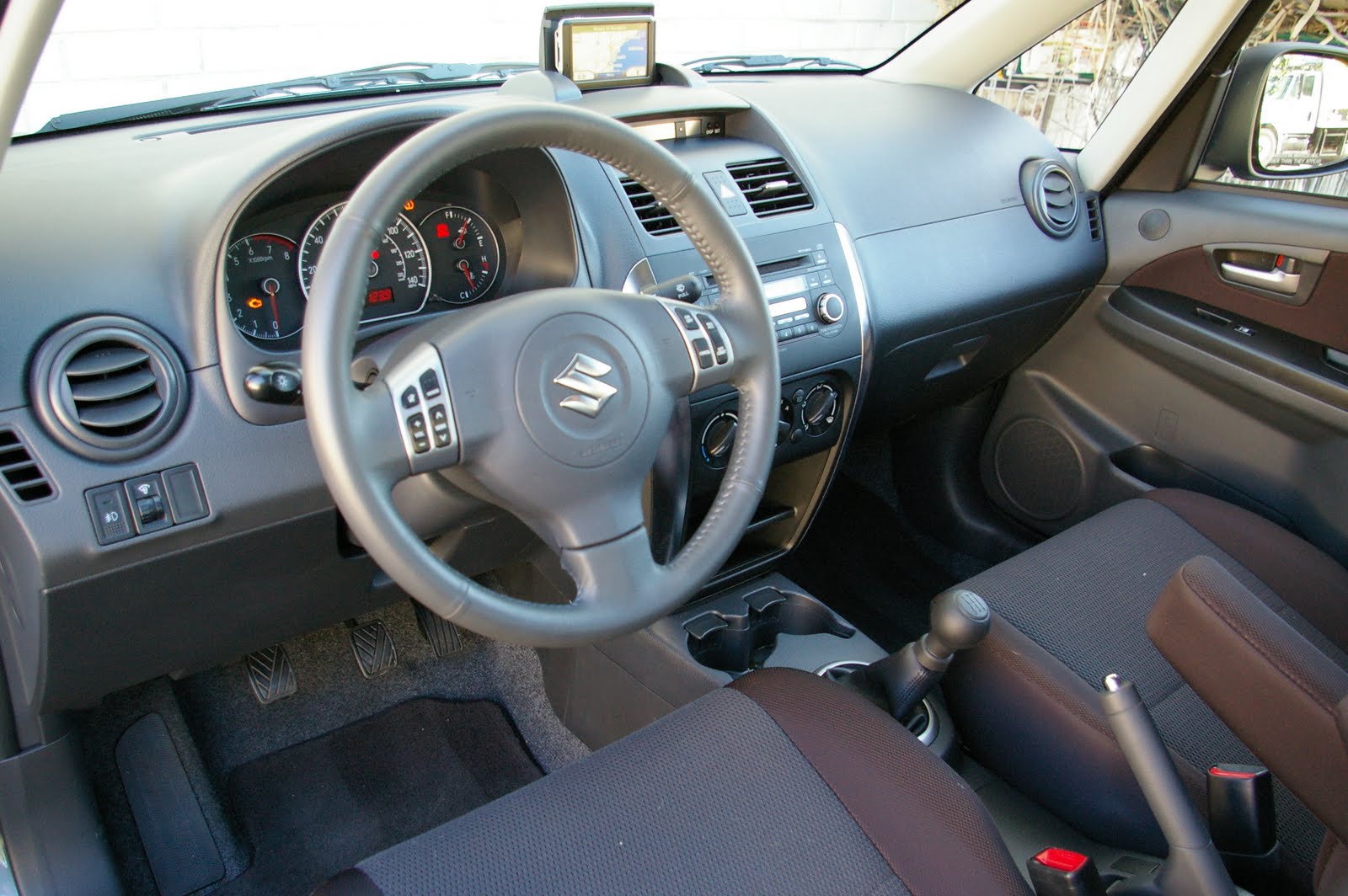 Interior: The older interior of the Suzuki SX4 is rather conventional and a  bit simple. The automatic transmission is a gated one while the CVT seems  like ...