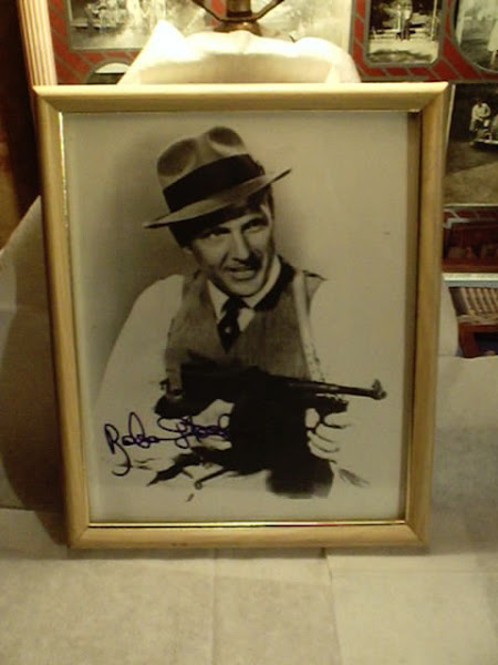 Signed photo of Robert Stack wearing the hat