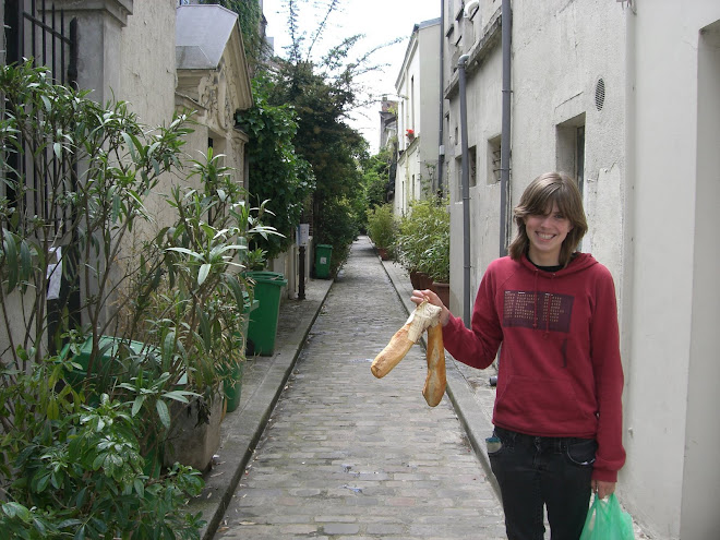 Rosena with baguette in front of our apt.