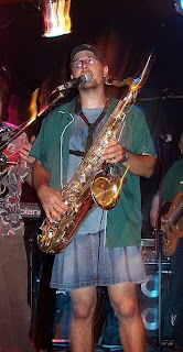 Guy in a Skirt playing a Saxophone