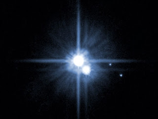Hubble photo image of Pluto and moons