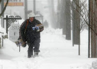 Letter carrier John Vazquez braves the snow as he delivers mail on his route Saturday, March 8, 2008 in Columbus, Ohio. A foot of snow buried parts of the Ohio and Tennessee valleys early Saturday, shutting down travel and many public events. Blizzard warnings remained in effect in Ohio, with winter storm warnings from Tennessee to upstate New York and northern Maine. Wind up to 35 mph whipped the snow and cut visibility to less than a quarter mile in places, the weather service said. (AP Photo/Kiichiro Sato)
