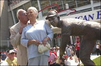 Joe Nuxhall kisses his wife Donzetta after unveiling a statue of himself in front of Great American Ball Park in 2003. Nuxhall was one of four Reds greats honored with statues when the ballpark opened. The others were Frank Robinson, Ted Kluszewski and Ernie Lombardi. Photo from the Cincinnati Enquirer