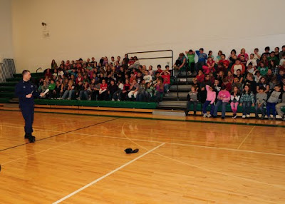 Master Chief Petty Officer Aaron Zimmer, officer-in-charge of Coast Guard Station Toledo, addresses fourth grade students at Margaretta Elementary School during ice safety training, Dec. 15, 2010. U.S. Coast Guard photo by Petty Officer 3rd Class George Degener.