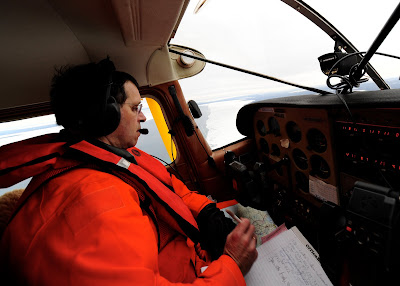 The Honorable Thomas G. Power, Chief Judge of the 13th Circuit Court in Traverse City, Mich., conducts a shoreline survey of ice formations as part of the Coast Guard Auxiliary Air, Jan. 17, 2011. U.S. Coast Guard photo by Petty Officer 3rd Class George Degener.