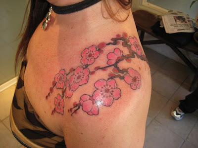 Pink Cherry Blossoms Tattoo at the Shoulder [Image Credit: Link]
