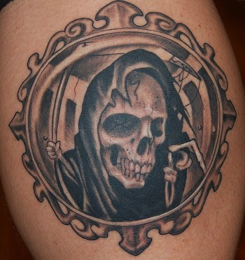 grim tattoo designs tattooing by using black and grey tattoo ink