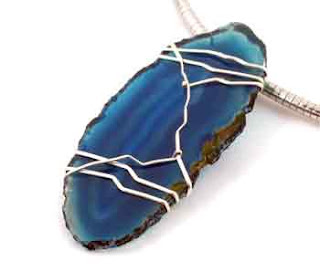 blueberry geode slice that has been wirewrapped in sterling silver