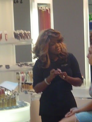 celebrity makeup artist brandy gomez duplessis working at the l'oreal cosmetics mall tour