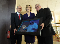 Artist Ian Fleming handing his jigsaw artwork to Irish President Mary McAleese at Ullans Academy's Columbanus Celebration