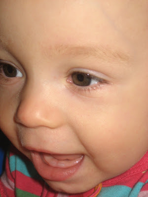 Logan-Heidi-Afton-Emery: First tooth at 10 months