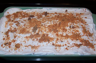 Top Butterfinger cake with Cool Whip and Butterfinger crumbs.