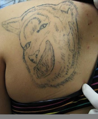 This tat wins the triple crown of bad tattooing.