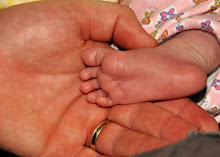 Daddy's hand and Brielle's tiny foot