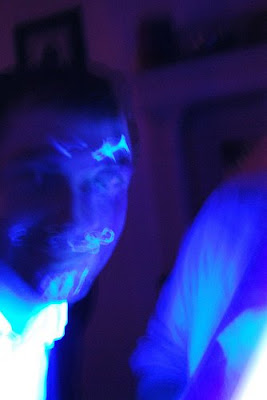 Rory and Spencer have a band. They are very awesome and fun. I'll tell you all about it later. face with glowing eyebrows, mustache and goatee drawn on