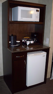 a small refrigerator and a cabinet