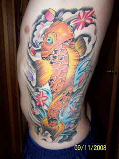 Koi fish is another popular tattoo design on ribs or rib cage especially 