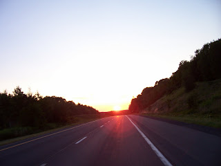 Road trip, setting sun on highway