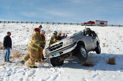 Powell volunteer firefighters work to right a wrecked car Powell volunteer firefighters work to right a wrecked car