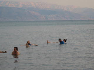 Floating in the Dead Sea with the Jordanian mountains in the background