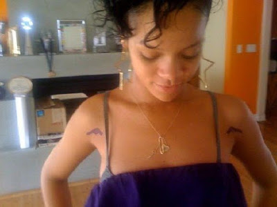 rihanna tattoos on hand. chris brown star tattoo.