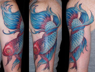 Blue koi tattoo picture with a red head on a man's sleeve.