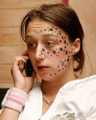 Star Tattoo Designs Young European celebrity girl with small black stars tattoo on her face.