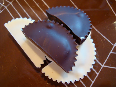 Two split Vegan White Chocolate Chocolate Peanut Butter Cups on plate