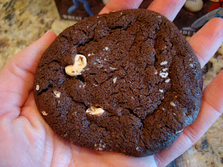 Hand holding one White Chocolate Brownie Cookie
