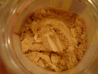 Overhead of powdered peanut butter in open jar